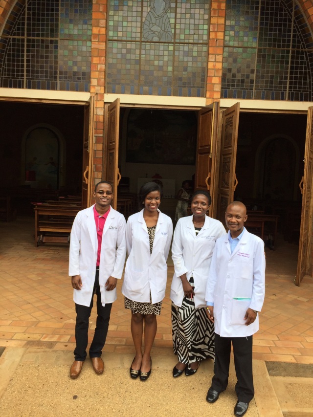 Aaron, Edel, Linda, and Joseph stand outside the beautiful Catholic Chapel on the Campus of Nsambya